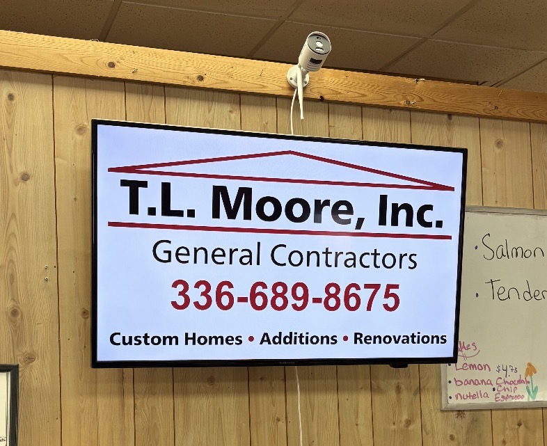 T. L. Moore advertisement on a TV in a local restaurant